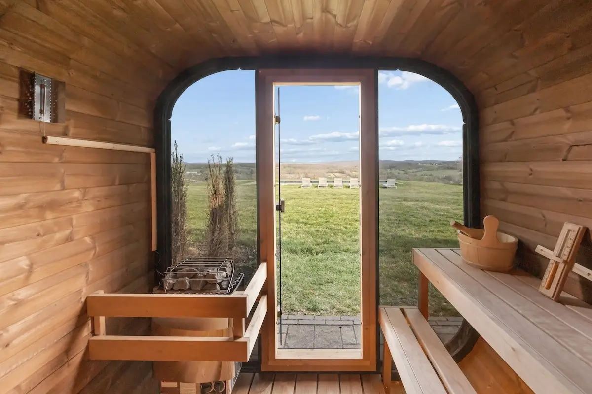 Cedar barrel sauna interior with glass door overlooking rolling hills at The Maple Overlook — private estate upstate NY