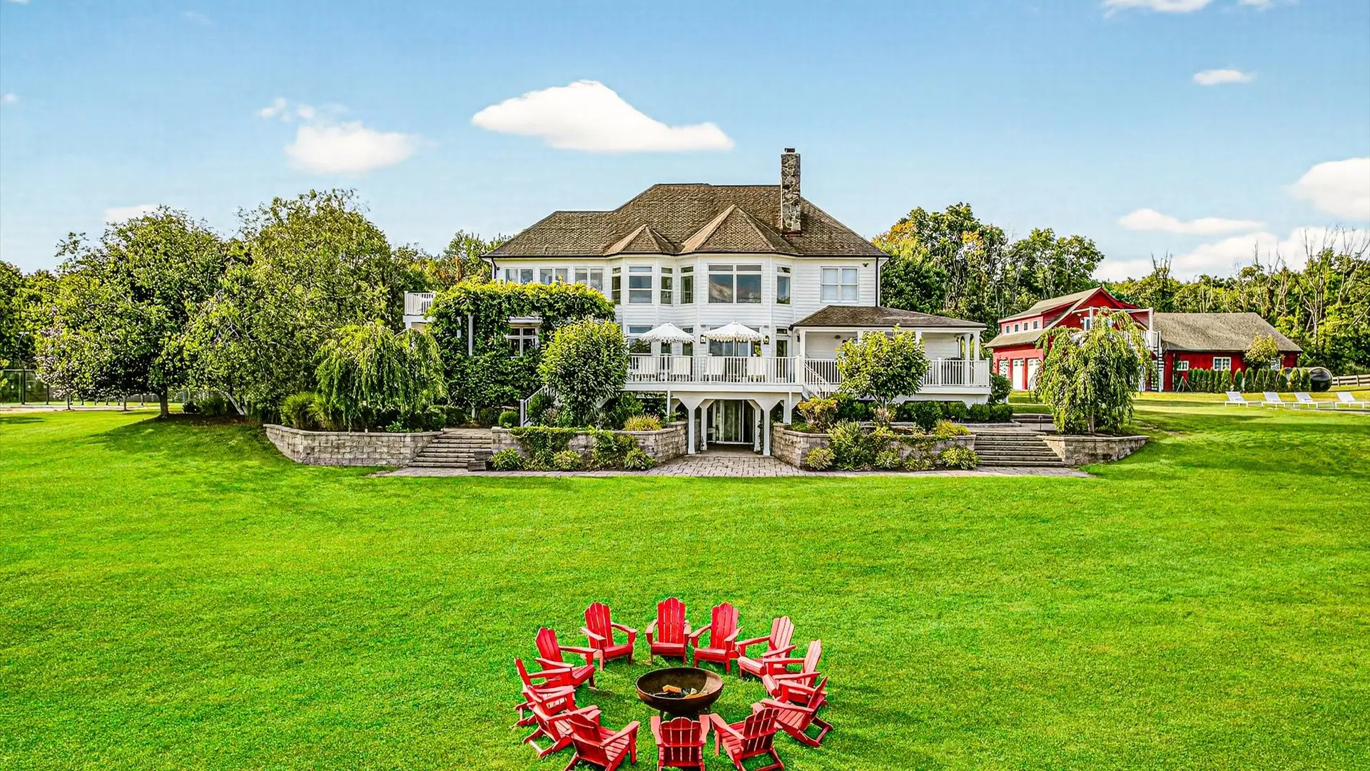 Heated outdoor pool and lawn beside the main house at The Maple Overlook