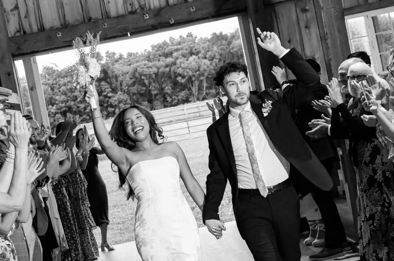 Bride and groom making their entrance at the barn at The Maple Overlook — black and white reception photograph