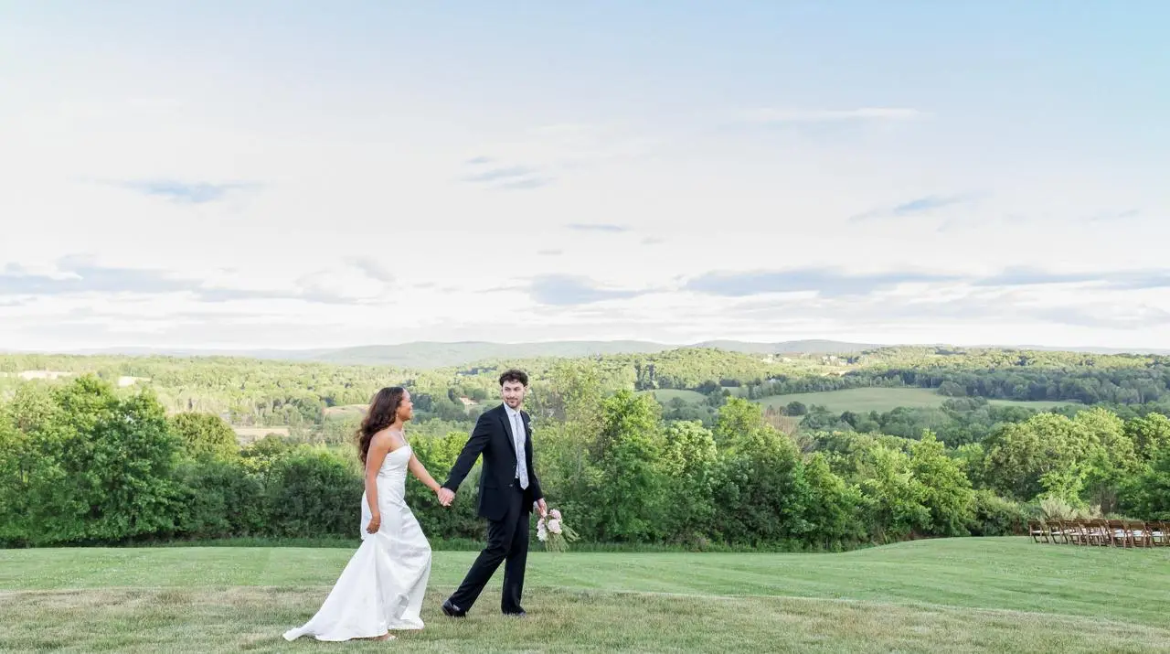 Bride and groom portrait on the estate lawn at The Maple Overlook with panoramic Hudson Valley views