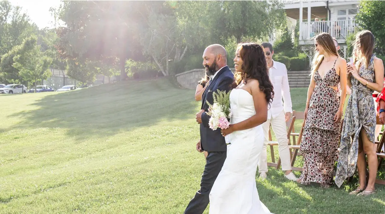 Bride walking down the aisle at the outdoor lawn ceremony at The Maple Overlook in upstate New York